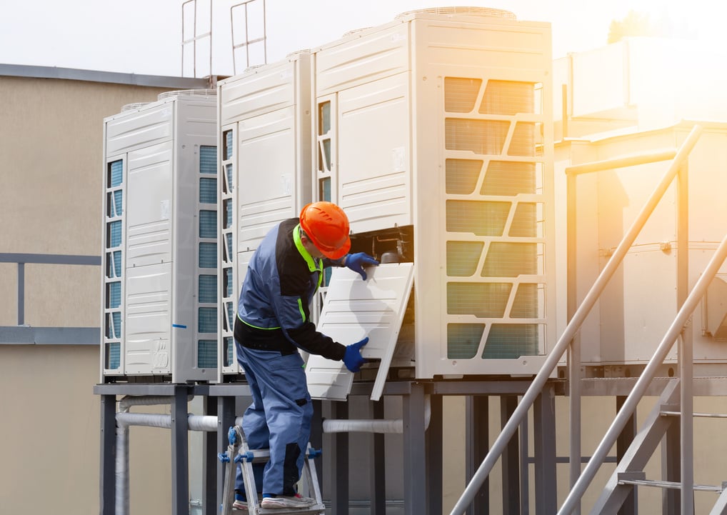 Technician Installing an Industrial Air Conditioner